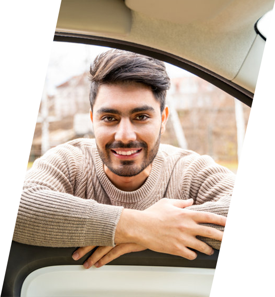 man leaning into car window smiling